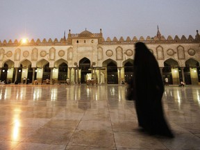 A niqab-clad woman walks outside the Al-Ahzar mosque in Cairo.