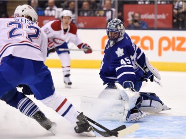 Toronto Maple Leafs goalie Jonathan Bernier makes a pad save on Montreal Canadiens' Dale Weise during first period season opener NHL action in Toronto on Wednesday, Oct. 7, 2015.