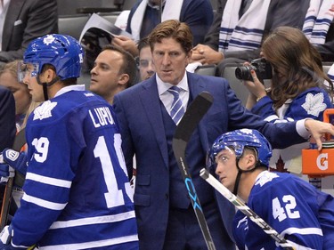 Toronto Maple Leafs head coach Mike Babcock stands behind the bench as his team plays the Montreal Canadiens during second period NHL action in Toronto on Wednesday, Oct. 7, 2015.