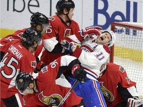 Montreal Canadiens' Brendan Gallagher (11) reacts as Ottawa Senators' Zack Smith (15) draws a roughing penalty in the Senators crease during the first period of a pre-season NHL hockey game, Saturday, Oct. 3, 2015, in Ottawa.