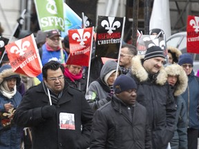 MONTREAL, QUE.: NOVEMBER 13, 2015 -- Public sector workers march along Peel Street during a demonsration in Montreal, Friday November 13, 2015.  It was part of continuing rotating strikes across the province.