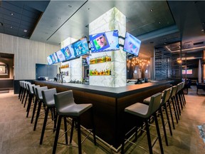 The Woods Jupiter, Tiger Woods's sophisticated sports bar in Florida, has an all-American menu and 38 large-screen TVs.