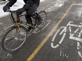 A cyclist makes his way down a bike path in Montreal Feb. 17, 2015.
