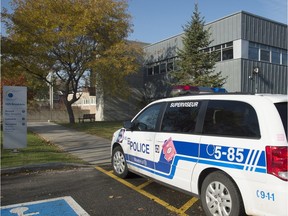 A Montreal police cruiser is shown outside the Lester B. Pearson School Board office in Montreal Tuesday, November 3, 2015. A number of bomb threats have been made against schools across the province.
