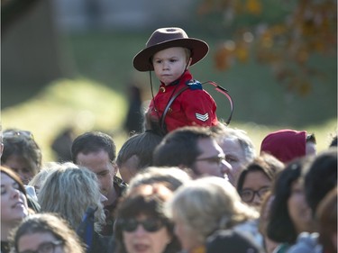 A youngster wearing a Mountie uniform waits for Prime Minister-designate Justin Trudeau and the Members of Parliament who will comprise his cabinet to arrive at Rideau Hall for a swearing-in ceremony in Ottawa on Wednesday, Nov. 4, 2015.