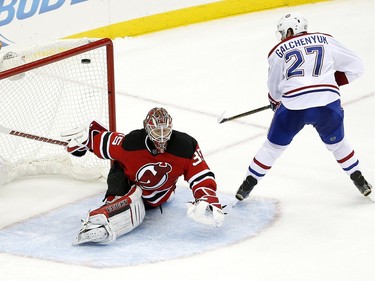 Canadiens' Alex Galchenyuk scores a goal on Devils goalie Cory Schneider during the shootout Friday, Nov. 27, 2015, in Newark, N.J. The Canadiens won 3-2.