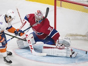 Montreal Canadiens goaltender Carey Price makes a save against New York Islanders' Anders Lee during first period NHL hockey action in Montreal Sunday, Nov. 22, 2015.