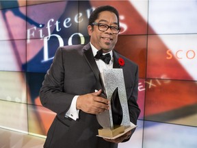 André Alexis stands on stage after winning the Giller Prize for his novel Fifteen Dogs during a gala ceremony in Toronto on Tuesday November 10, 2015. The book — about 15 dogs gifted by gods with human traits — was praised by jury members as an "insightful and philosophical meditation on the nature of consciousness.''