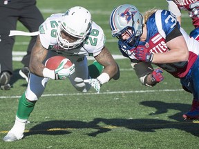 Montreal Alouettes' James Tuck, right, tackles Saskatchewan Roughriders' Anthony Allen during first half CFL football action, in Montreal, on Sunday, Nov. 8, 2015.