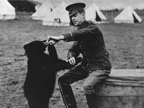 Archive photo shows Lt. Harry Colebourn, a veterinarian, feeding the bear cub he adopted near White River, Ont and named Winnie in honour of his hometown of Winnipeg.