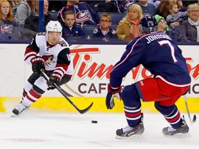 Max Domi of the Arizona Coyotes attempts to skate past Jack Johnson of the Columbus Blue Jackets during the third period on Nov. 14, 2015, at Nationwide Arena in Columbus, Ohio.