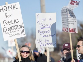 Teachers demonstrate outside a high school in Montreal Nov. 16, 2015, to protest against cuts by the Quebec government.