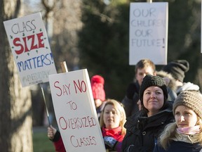 School teachers demonstrate outside a high school near Montreal, Monday, Nov. 16, 2015, where they protested against the ongoing austerity cuts by the Quebec government.