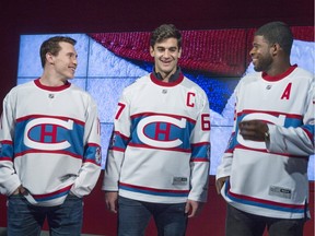 Montreal Canadiens' Brendan Gallagher, Max Pacioretty, and P.K. Subban, left to right, show off the team's jersey to be worn during the 2016 NHL Winter Classic Friday, November 6, 2015 in Montreal. The Canadiens will face the Boston Bruins at Gillette Stadium, home of the NFL's New England Patriots, on January 1, 2016.