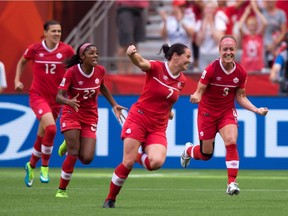 Canada's Rhian Wilkinson, No. 7, with Christine Sinclair, left to right, Ashley Lawrence, and Josee Belanger, celebrate Belanger's goal against Switzerland during the second half of the FIFA Women's World Cup in Vancouver, B.C., on June 21, 2015. Rhian Wilkinson's return to the starting lineup paid huge dividends for Canada at the Women's World Cup.