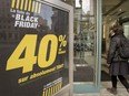 A woman enters a clothing store in Montreal on Black Friday on Nov. 23, 2012.