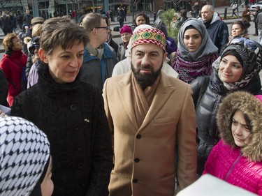 Catherine Feuillet (left), French consul general in Montreal, speaks with members of the Montreal chapter of an organization called the Association of Islamic Charitable Projects outside the French consulate in Montreal Sunday, Nov. 15 , 2015, after a march in solidarity with Paris.