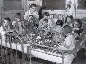 This photo, which was published in The Gazette on Dec. 17, 1955, was captioned: "All of these children will be well enough to go home for Christmas, even if just for the day. Here Nurse Margaret Goodenough helps them prepare Christmas decorations for the hospital's Tiny Tim Party next Wednesday, for those who have to stay.