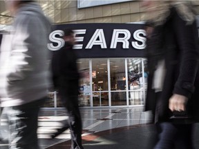 Commuters walk past a Sears store in Toronto.