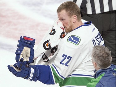 Vancouver Canucks left wing Daniel Sedin (22) heads to the bench after taking a high stick during first period National Hockey League action against the Montreal Canadiens Monday, November 16, 2015 in Montreal.