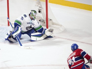 Montreal Canadiens centre David Desharnais (51) scores the winning goal on Vancouver Canucks goalie Jacob Markstrom (25) during the overtime period against the Vancouver Canucks in National Hockey League action Monday, November 16, 2015 in Montreal.