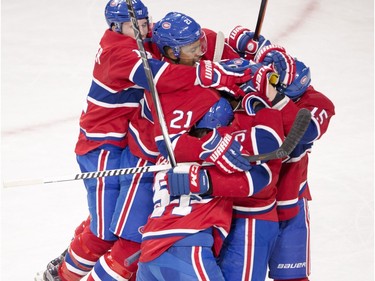 Montreal Canadiens centre David Desharnais (51) is mobbed by teammates after scoring the winning goal during the overtime period against the Vancouver Canucks in National Hockey League action Monday, November 16, 2015 in Montreal.
