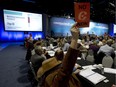 Delegates vote on a motion during a policy plenary session during the Conservative Convention in Calgary, Saturday, Nov. 2, 2013.