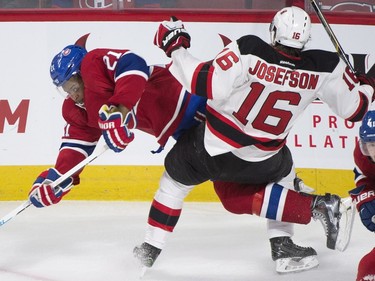 New Jersey Devils' Jacob Josefson (16) collides with Montreal Canadiens' Devante Smith-Pelly during second period NHL hockey action, in Montreal, on Saturday, Nov. 28, 2015.
