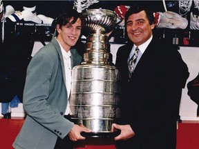 Canadiens defenceman Patrice Brisebois (age 22) poses with general manager Serge Savard after the team won the Stanley Cup in 1993.