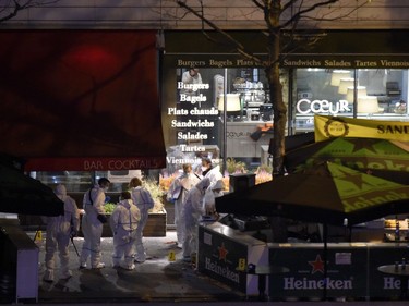 Forensic experts inspect the site of an attack, a restaurant outside the Stade de France stadium in Saint-Denis, north of Paris, early on November 14, 2015, after a series of gun attacks occurred across Paris as well as explosions outside the national stadium where France was hosting Germany. Dozens were killed and many injured in a series of gun attacks across Paris, as well as explosions outside the national stadium where France was hosting Germany.