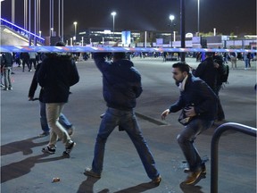 Spectators leave the Stade de France stadium after the stadium was locked by authorities following the friendly football match between France and Germany in Saint-Denis, north of Paris, on November 13, 2015, after a series of gun attacks occurred across Paris as well as explosions outside the national stadium where France was hosting Germany. At least 18 people were killed, with at least 15 people killed at the Bataclan concert hall in central Paris, only around 200 metres from the former offices of Charlie Hebdo which were attacked by jihadists in January.