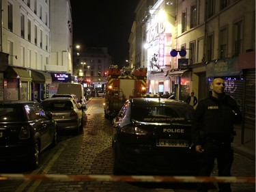 Police secure the area following an attack in the 10th arrondissement of the French capital Paris, on November 13, 2015. At least 18 people were killed as multiple shootings and explosions hit Paris, police said.