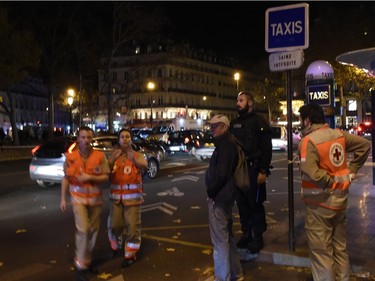 Rescue workers stand near Place de la Republique square in Paris on November 13, 2015.