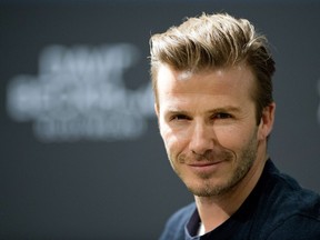 A file photo taken on March 19, 2013 shows British footballer David Beckham attending a commercial assignment at H&M store in Berlin.