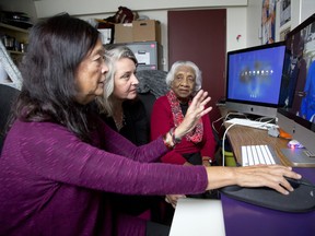 Dr. Kim Sawchuk (centre) helps seniors Anne Caines (left) and Madhu Nambiar with picture and video editing.