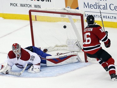 New Jersey Devils center Jacob Josefson (16), of Sweden, scores on Montreal Canadiens goalie Mike Condon (39) during the shootout in an NHL hockey game Friday, Nov. 27, 2015, in Newark, N.J. The Canadiens won 3-2.