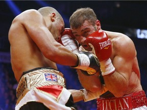 James Degale of England throws a punch to Lucian Bute of Canada during their IBF super-middleweight championship fight at Centre Vidéotron on Nov. 29, 2015, in Quebec City.