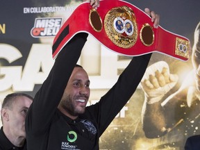James DeGale raises his IBF belt at a news conference for Super Middleweight IBF world championship fight against Lucian Bute, Nov. 25, 2015 in Quebec City. The fight will be held on Saturday Nov. 28, 2015 at the Vidéotron Centre in Quebec City.