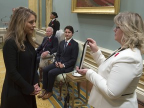 Governor General David Johnston and Prime Minister Justin Trudeau look on as Mélanie Joly is sworn in as the Minister of Canadian Heritage during ceremonies at Rideau Hall Wednesday Nov. 4, 2015 in Ottawa.