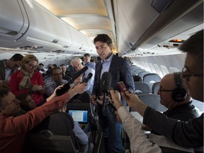 Prime Minister Justin Trudeau speaks to reporters while flying from Antalya, Turkey to Manila, Philippines on Tuesday, Nov. 17, 2015, to attend the APEC Summit.