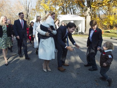 Hadrien Trudeau runs into his father's arms as Prime Minister-designate Justin Trudeau, his wife Sophie Gregoire-Trudeau, holding daughter Ella-Grace and their oldest son Xavier arrive at Rideau Hall with Trudeau's future cabinet to take part in a swearing-in ceremony in Ottawa on Tuesday, November 4, 2015.