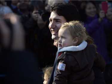 Prime Minister-designate Justin Trudeau holds son Hadrien they arrive at Rideau Hall with Trudeau's future cabinet to take part in a swearing-in ceremony in Ottawa on Tuesday, November 4, 2015.