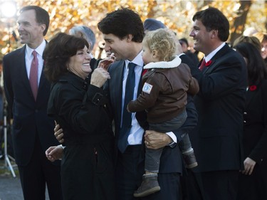 Prime Minister-designate Justin Trudeau holds his son Hadrien while hugging his mother Margaret outside Rideau Hall in Ottawa on Tuesday, November 4, 2015.