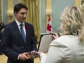 Justin Trudeau takes the oath of office as he is sworn in as prime minister at Rideau Hall in Ottawa on Wednesday, November 4, 2015.