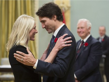 Prime Minister Justin Trudeau hugs Environment and Climate Change Minister Catherine McKenna at Rideau Hall in Ottawa on Wednesday, November 4, 2015.