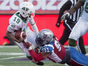 Saskatchewan Roughriders' Keith Price (19) is sacked by Montreal Alouettes' Alan-Michael Cash during second half CFL football action, in Montreal, on Sunday, Nov. 8, 2015.