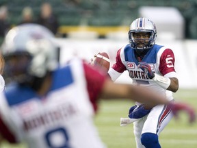 Montreal Alouettes' quarterback Kevin Glenn (5), right, looks for the pass against the Edmonton Eskimos during first half CFL football action in Edmonton on Sunday.