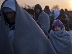 Refugees wait to enter a registration camp near Gevgelija, Macedonia, on Oct. 30.