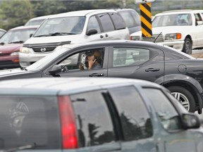 Man uses a cell phone while driving on St-Jean Blvd. in Pointe-Claire Thursday, July 5, 2007. (THE GAZETTE/John Kenney)