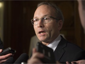 Quebec Treasury board president Martin Coiteux responds to reporters questions over striking civil servants Tuesday, October 27, 2015 in Quebec City.